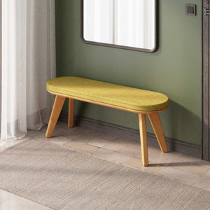 Yase Bench 120 x 38, sarı keten döşemeli oturum ve masif kayın gövde, döşenmiş oda ortamında kullanım görünümü
